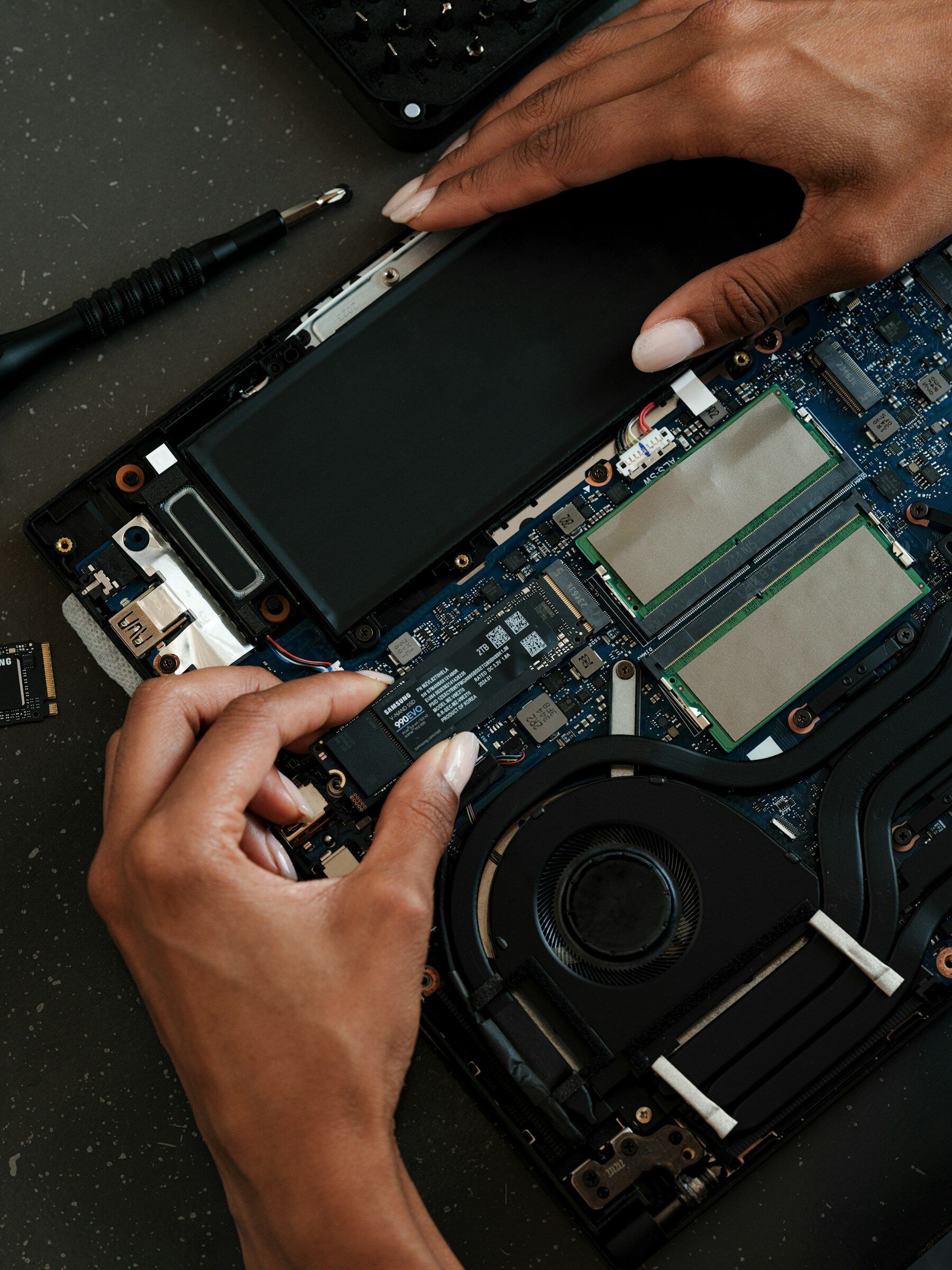Open laptop internals with SSD and components on the repair bench